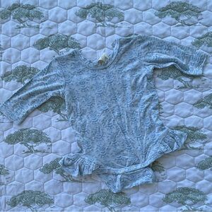 Kate Quinn ruffle leg bodysuit